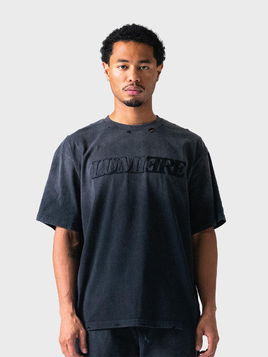 Model draagt Lumi3re Fade Logo T-Shirt in Washed Black