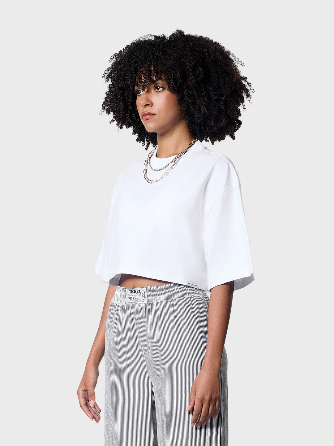 Model draagt Off The Pitch Lana Cropped Tee | White – schuin vooraanzicht