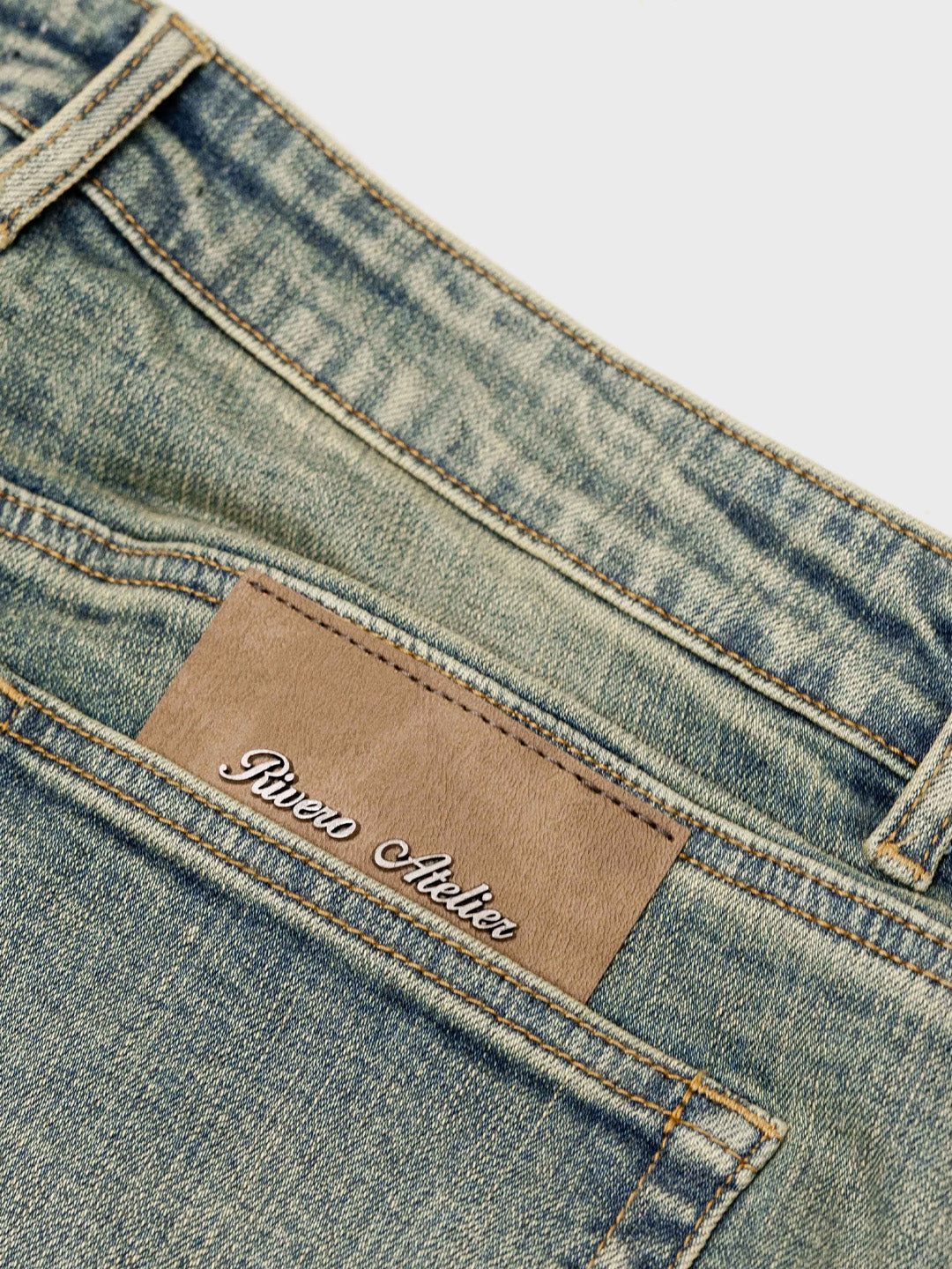 Rivero Raised Monogram Jeans Pale – close-up patch