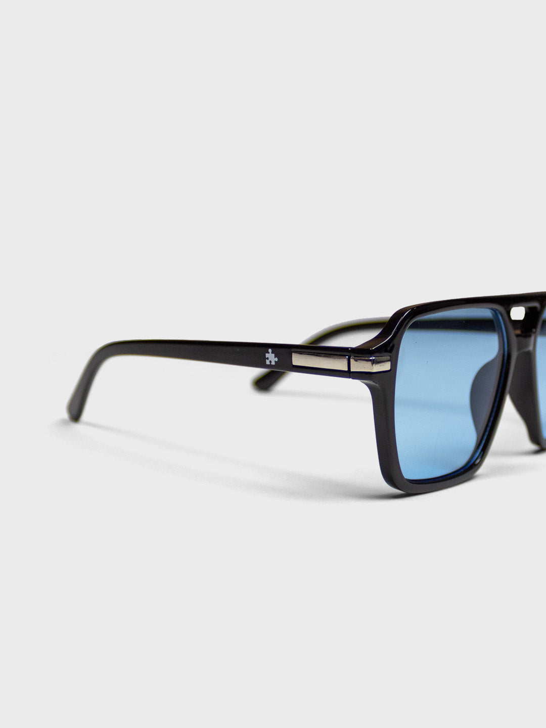 The Missing Piece Aviator Shades Black/Blue – close-up puzzle piece logo