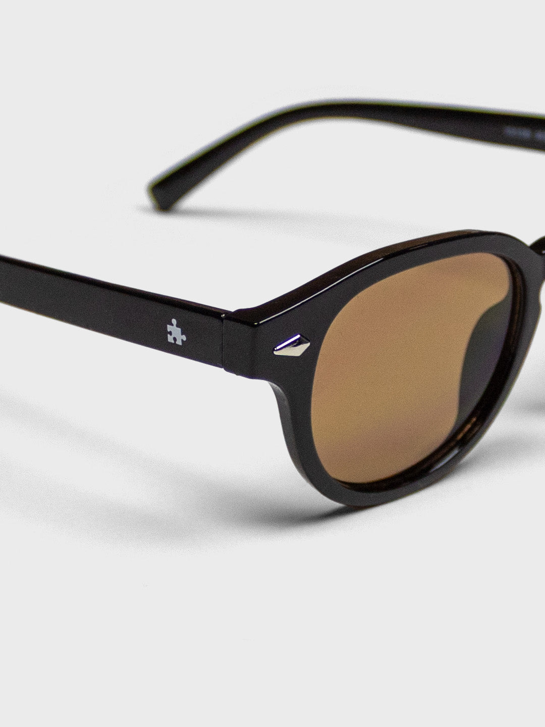 The Missing Piece bril - zwart/bruin - close-up logo