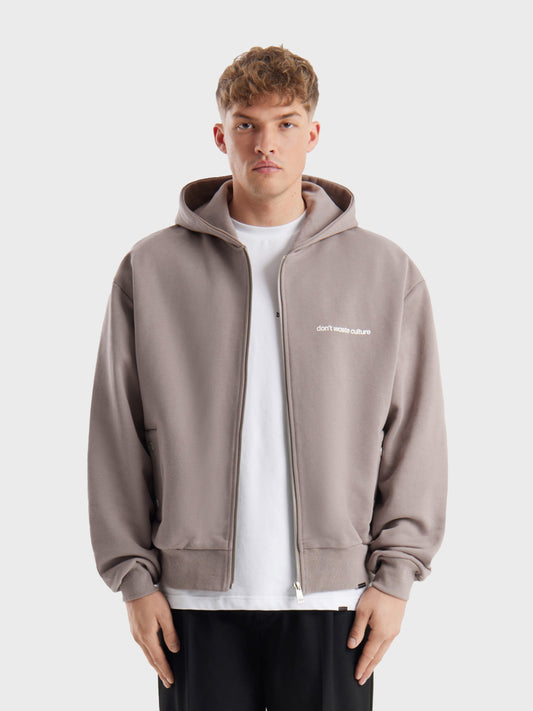 Model draagt DWC Ale Zip Hoodie in Warm Grey