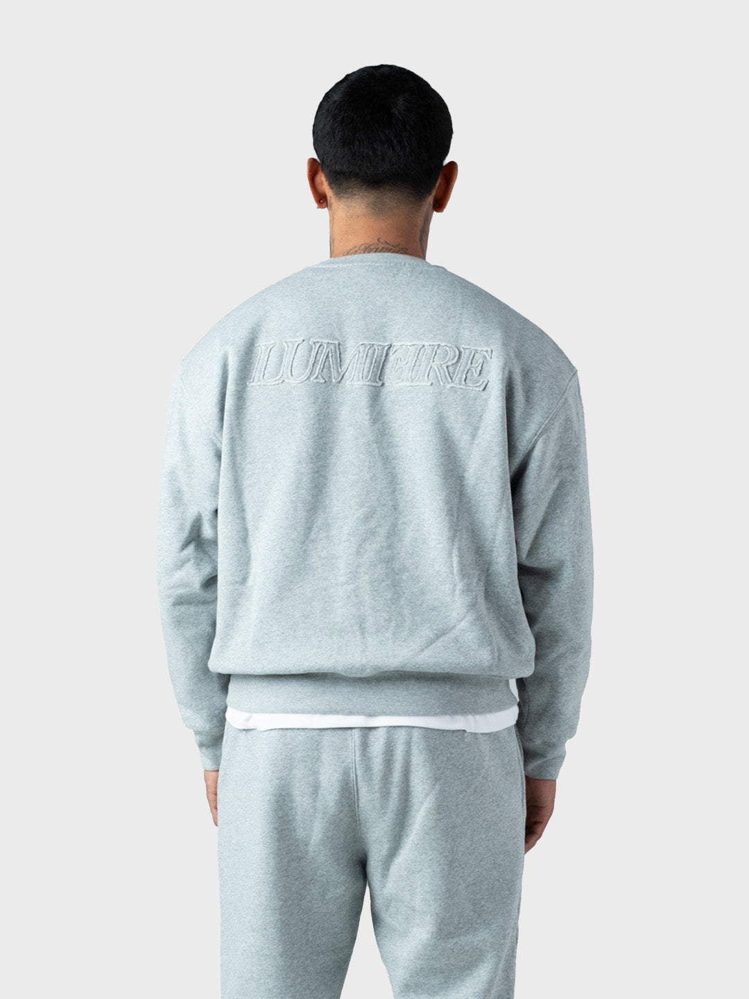 model in Lumi3re Hero Tracksuit - rug graphic