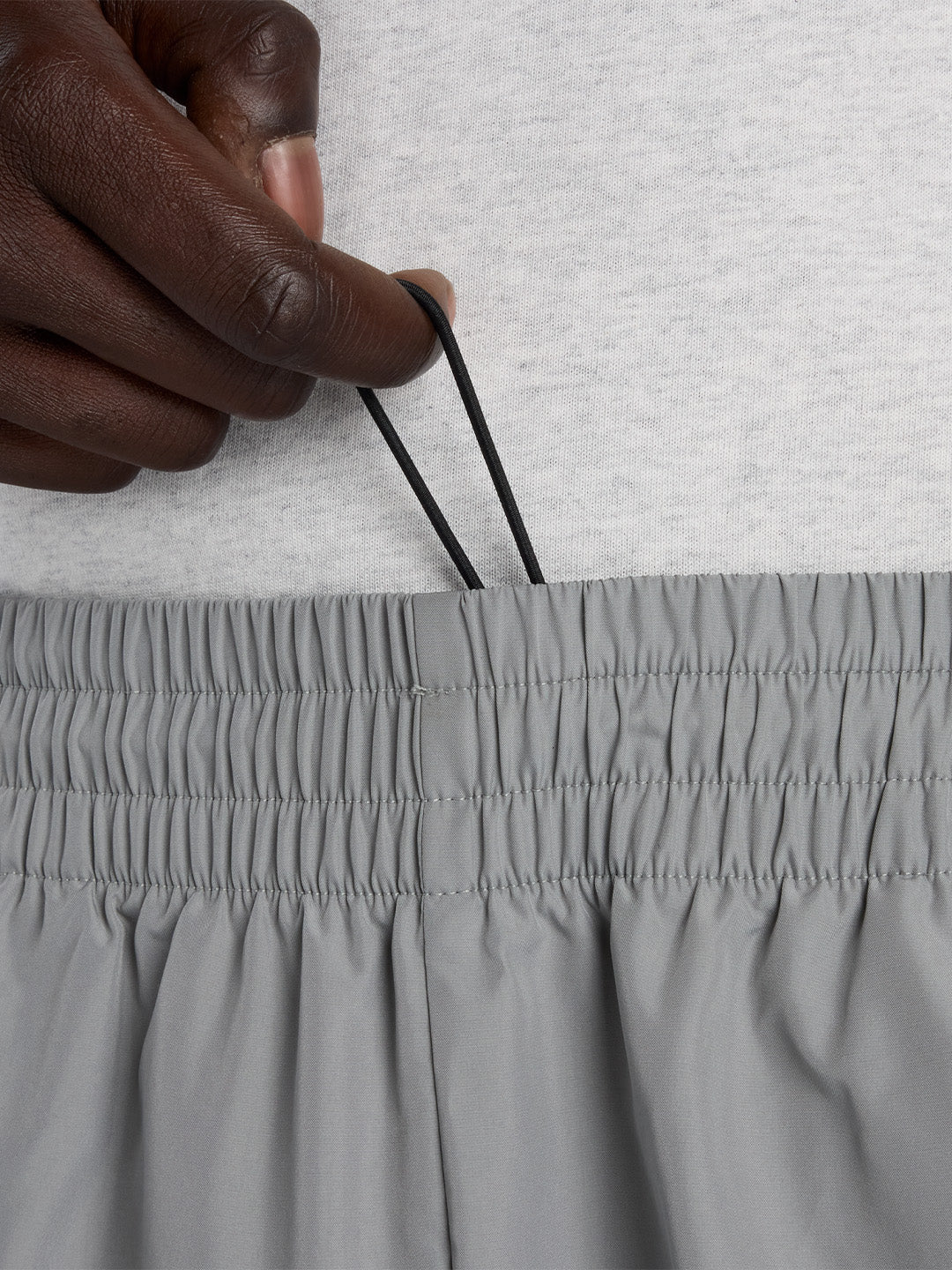 New Balance Elusive Shell Pants Slate Grey - close-up verborgen trekkoord