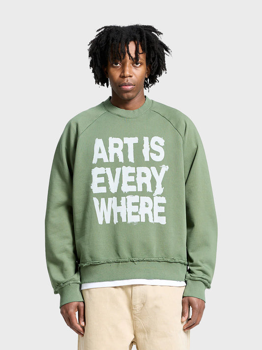 Reternity Art Is Everywhere Crewneck Green – model front view met geschilderde tekst