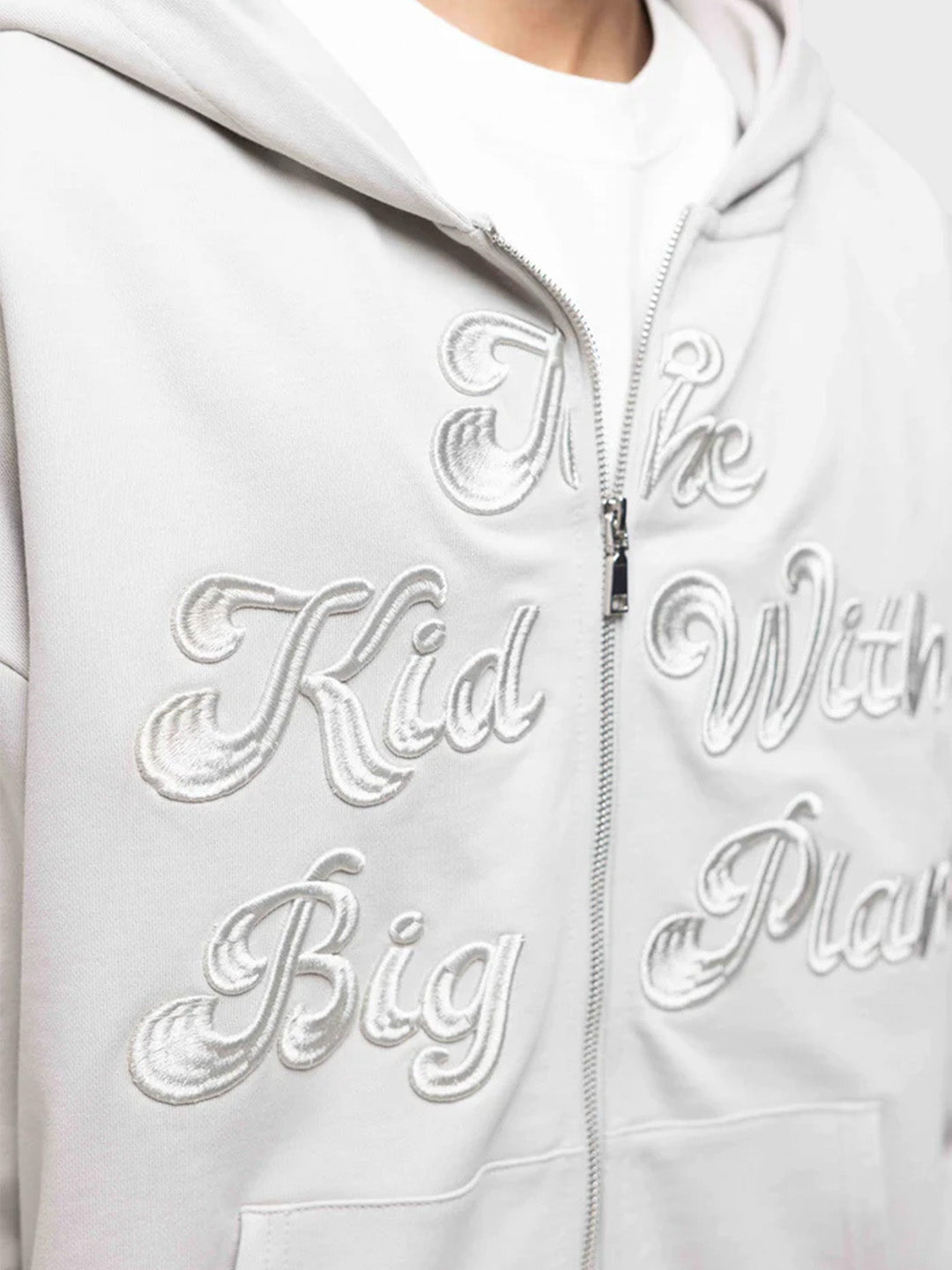 Close-up van geborduurde ‘The Kid With Big Plans’ graphic op de voorkant