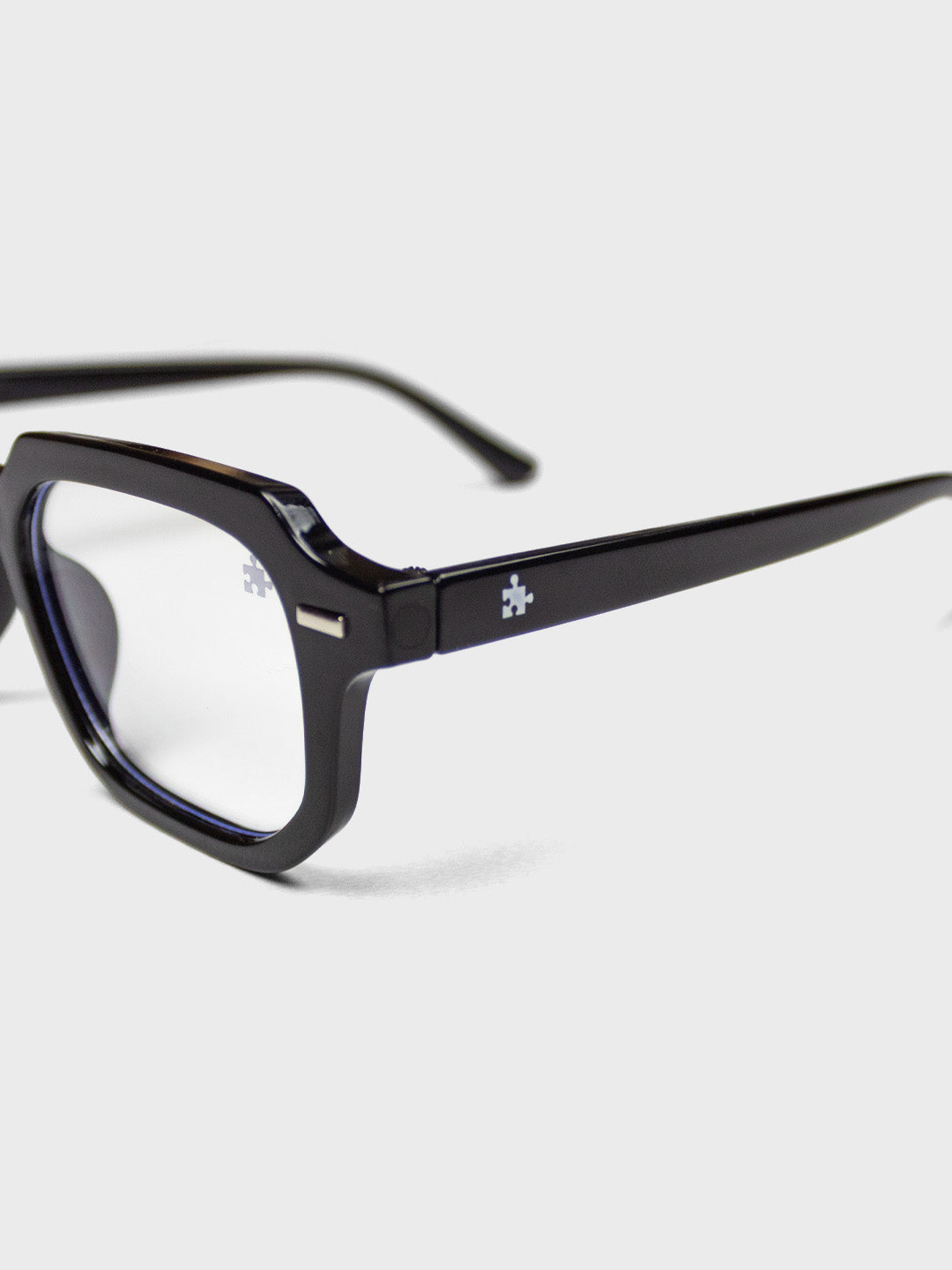 The Missing Piece Ryma B-Filter Shades Black - close-up puzzle piece logo